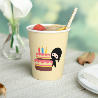 Tiny Ninja Behind Birthday Cake on Yellow Paper Cups