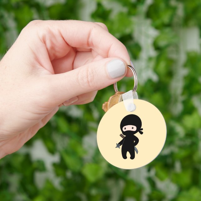 Tiny Ninja Holding Throwing Star on Yellow Keychain (Hand)