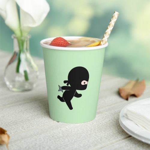 Tiny Ninja Running on Green Paper Cups