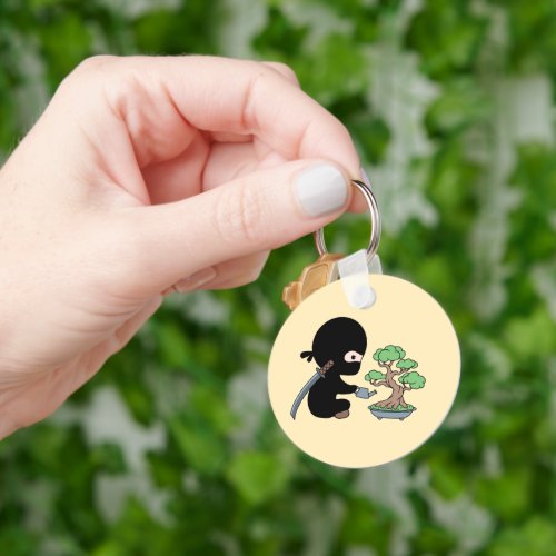 Tiny Ninja Watering Bonsai Tree on Yellow Keychain