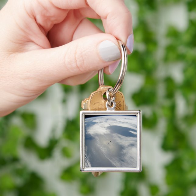 Tiny Satellites Orbit Above A Part Of Earth. Keychain (Hand)