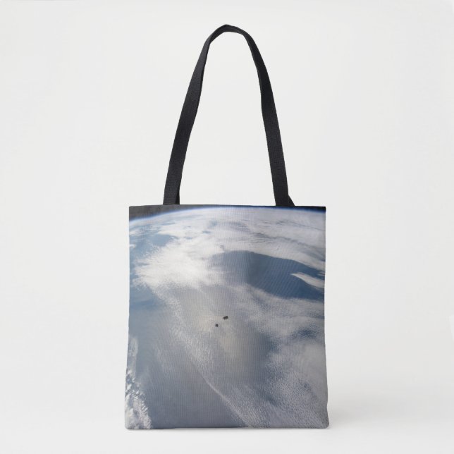 Tiny Satellites Orbit Above A Part Of Earth. Tote Bag (Front)