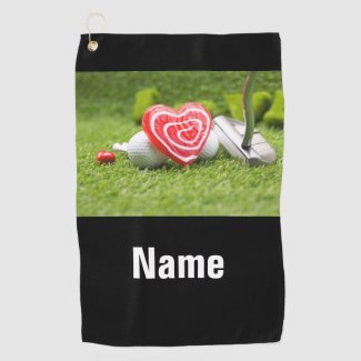 To golfer with love and golf ball on green golf towel