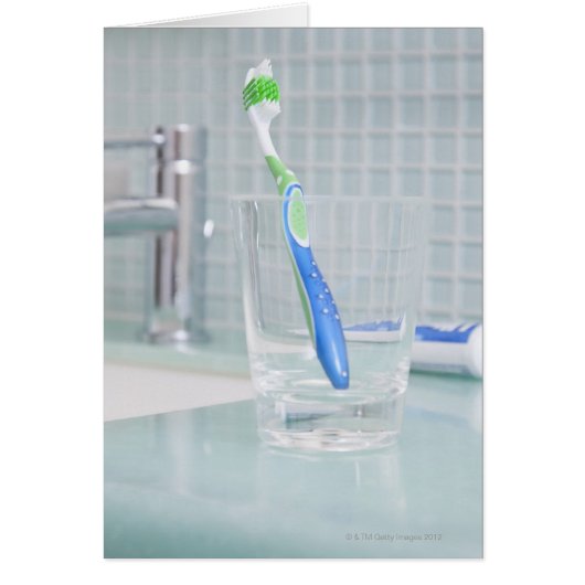 Toothbrush in a cup in the bathroom (Front)