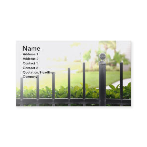 top of an outdoor black iron fence business card