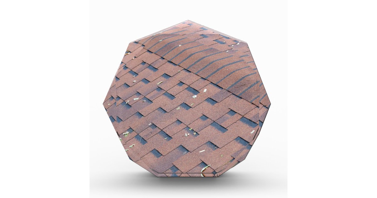 Top view of brown roof shingles with a few autumn award ...