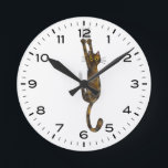 Tortoise Shell Cat Hanging On Funny Round Clock<br><div class="desc">A humorous wall clock for the home or office. Tortoise shell cat hanging on with claws. Makes an original gift for tortie lovers. Check out Jenn’s Doodle World for even more novelty clocks and animal themed home decor.</div>