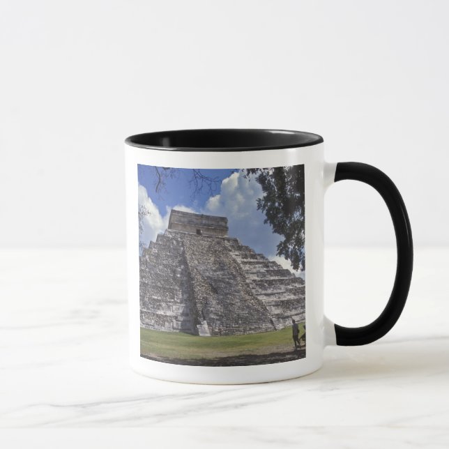 Tourists walk past an unrestored side of El 2 Mug (Right)