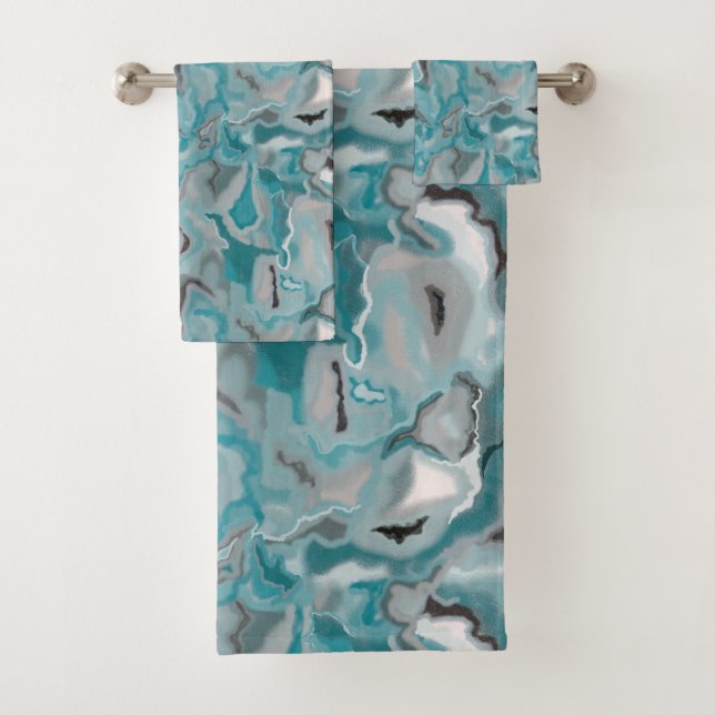 Towel with a turquoise gray abstract pattern. (Insitu)