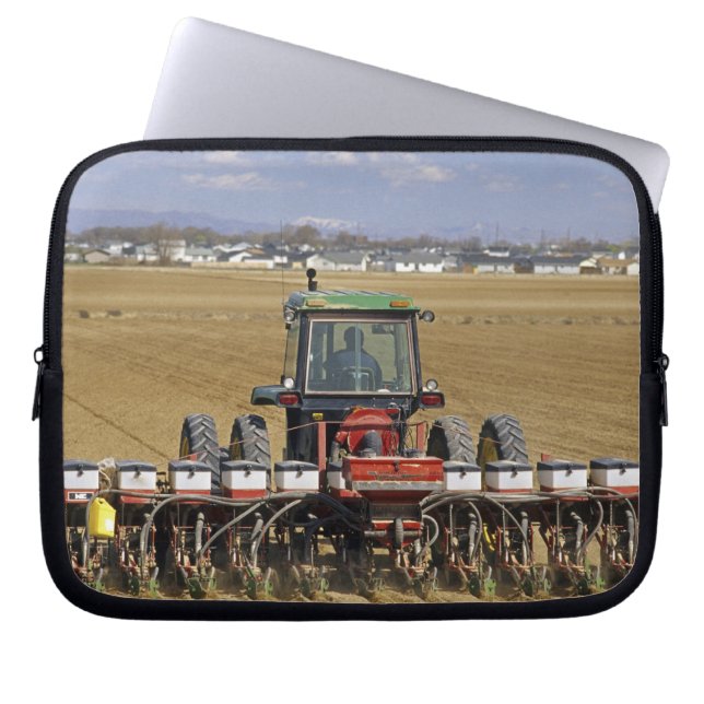 Tractor pulling a seed corn planter. laptop sleeve (Front)