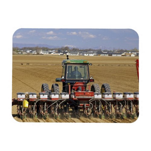 Tractor pulling a seed corn planter magnet