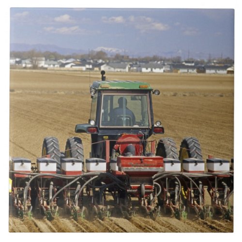 Tractor pulling a seed corn planter tile