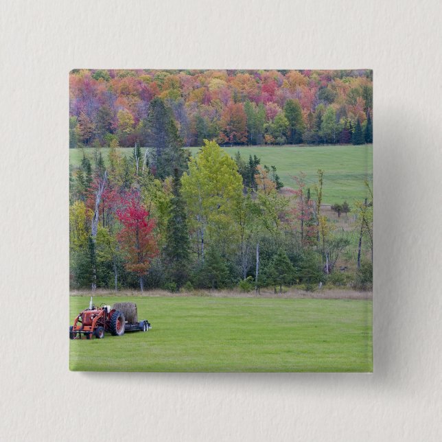 Tractor with hay bale in green field with pinback button (Front)