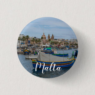 Traditional colorful fishing boats in Malta Button