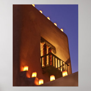Traditional farolitos light up adobe structures poster