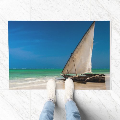 Traditional fishing boat on the beach doormat