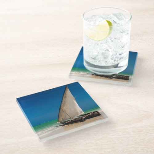 Traditional fishing boat on the beach glass coaster
