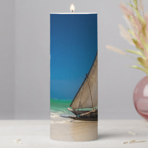 Traditional fishing boat on the beach pillar candle