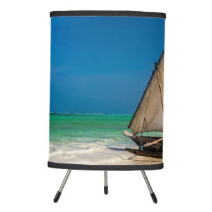 Traditional fishing boat on the beach tripod lamp