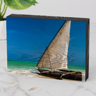 Traditional fishing boat on the beach wooden box sign