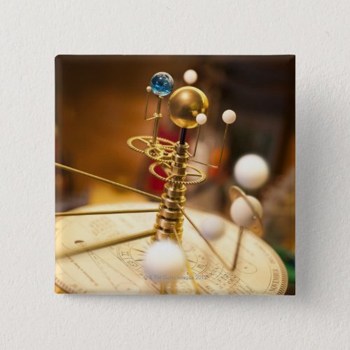 Traditional handcrafted brass orrery with the pinback button