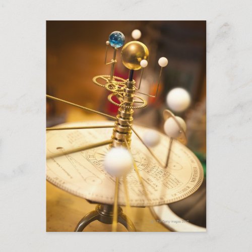 Traditional handcrafted brass orrery with the postcard