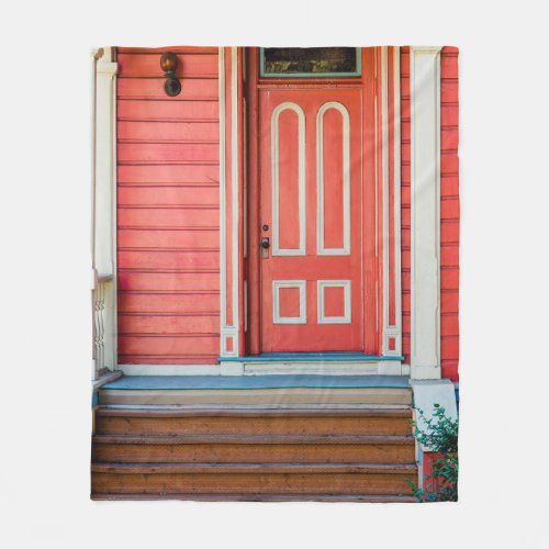 Traditional red painted wooden door and porchdoor fleece blanket