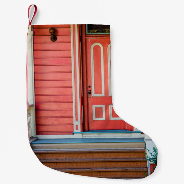 Traditional red painted wooden door and porchdoor, small christmas stocking (Front)