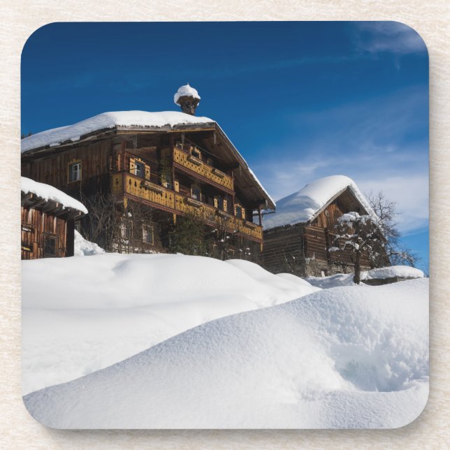 Traditional wooden cabins in de snow beverage coaster (Front)