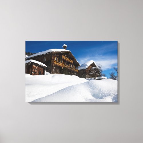 Traditional wooden cabins in de snow canvas print