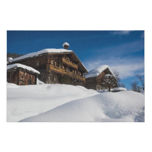 Traditional wooden cabins in de snow faux canvas print