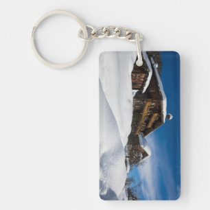 Traditional wooden cabins in de snow keychain