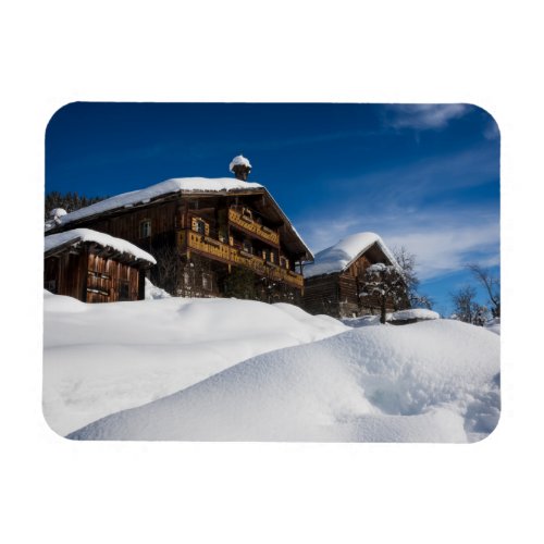Traditional wooden cabins in de snow magnet