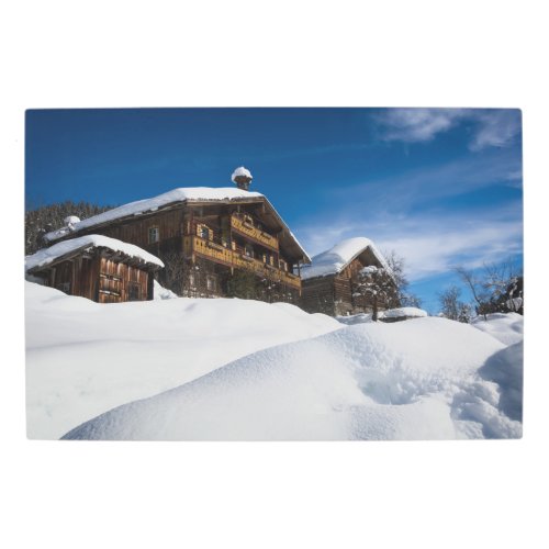 Traditional wooden cabins in de snow metal print