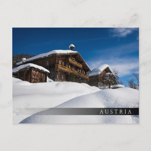 Traditional wooden cabins in de snow postcard