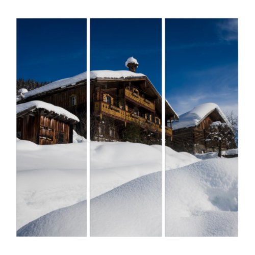 Traditional wooden cabins in de snow triptych