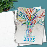 Tree of Life Personalized 2023 Planner<br><div class="desc">This unique Planner is decorated with a brightly colored Tree of Life on a pale gray background. The original design was made in mosaic using tiny pieces of brightly colored glass. Customize it with your name and year. To edit further use the Design Tool to change the font, font size,...</div>