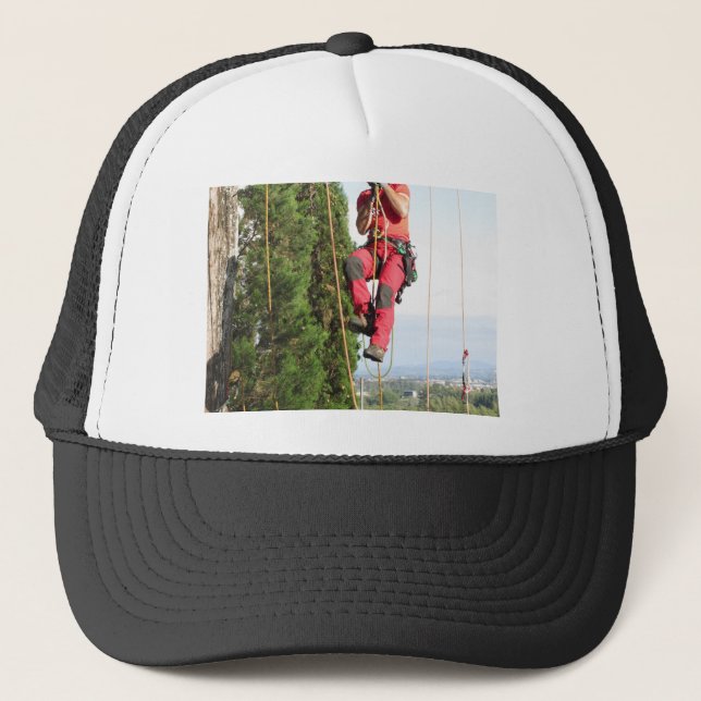 Tree surgeon lumberjack hanging from a big tree trucker hat (Front)