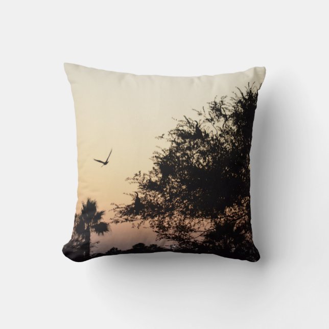 trees and flying bird against florida sunset throw pillow (Front)