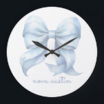 Trendy Blue Bow Personalized With Name Monogram Large Clock<br><div class="desc">Add a touch of timeless elegance to your decor with the Trendy Blue Bow Personalized With Name Monogram Large Clock. Featuring a delicate preppy coquette bow in a soft watercolor style, this clock effortlessly blends vintage charm with modern aesthetics. Its grandmillennial decor appeal makes it a perfect centerpiece for any...</div>