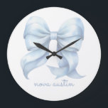 Trendy Blue Bow Personalized With Name Monogram Large Clock<br><div class="desc">Add a touch of timeless elegance to your decor with the Trendy Blue Bow Personalized With Name Monogram Large Clock. Featuring a delicate preppy coquette bow in a soft watercolor style, this clock effortlessly blends vintage charm with modern aesthetics. Its grandmillennial decor appeal makes it a perfect centerpiece for any...</div>