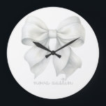Trendy White Bow Personalized With Name Monogram Large Clock<br><div class="desc">Add a touch of elegance and personalization to any space with the Trendy White Bow Personalized With Name Monogram Large Clock. This exquisite clock features a stylish white bow design, perfect for those who appreciate a trendy aesthetic and vintage charm. Ideal for a baby girl’s room, this clock enhances the...</div>