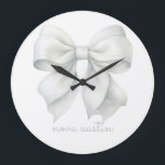 Trendy White Bow Personalized With Name Monogram Large Clock<br><div class="desc">Add a touch of elegance and personalization to any space with the Trendy White Bow Personalized With Name Monogram Large Clock. This exquisite clock features a stylish white bow design, perfect for those who appreciate a trendy aesthetic and vintage charm. Ideal for a baby girl’s room, this clock enhances the...</div>