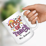 Trick or Teach Retro Pastel Halloween Teacher Name Coffee Mug<br><div class="desc">Celebrate Halloween this season with this adorable teacher Trick or Teach coffee mug. Featuring a retro pastel design with a ghost,  pencils,  bats and a rainbow. Personalize with your favorite teacher's name.</div>