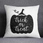 Trick or Treat Black Halloween Pumpkin Throw Pillow<br><div class="desc">Celebrate Halloween in style with this "trick or treat" seasonal throw pillow featuring modern script lettering on a black rustic textured pumpkin.</div>