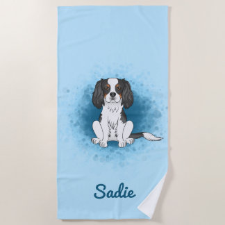 Tricolor Cavalier King Charles Spaniel Dog On Blue Beach Towel