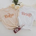 TRIXIE Retro 70's Themed Groovy Babe Bachelorette T-Shirt<br><div class="desc">This babe bachelorette t shirt features a retro 70's themed font in creamy orange coloring. Order the white bride option for the bride-to-be and the coordinating orange 'babe' shirts for your bachelorette group. Colors are editable! Click 'edit design' to create your own colors.</div>