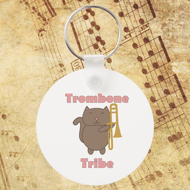 Trombone Tribe Cute Cat Pink Letters Keychain (A keychain with a brown cat holding a trombone and the words trombone tribe in pink.)