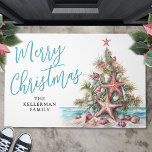 Tropical Beach Merry Christmas Doormat<br><div class="desc">Celebrate the season with this festive and beachy horizontal welcome doormat, perfect for greeting guests with a coastal twist. The design features a whimsical green Christmas tree made of beach shells, decorated with red and tan starfish and ornaments. At the base of the tree, soft sand and a splash of...</div>