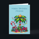 Tropical Christmas Palm Tree Birthday Card<br><div class="desc">Birthday card with a seasonal holiday image. A tropical palm tree decorated in festive lights with a star on top. A giant red and white candy cane sticking out of the sand. Gifts under the tree. Whimsical and fun.</div>
